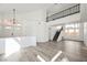 Open-concept living room with modern staircase and railing, wood floors, and lots of natural light at 124 Countrywood Cir, Las Vegas, NV 89107