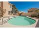 Refreshing kidney-shaped pool with a safety handrail, perfect for relaxing and entertaining outdoors at 124 Countrywood Cir, Las Vegas, NV 89107