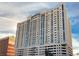 Condo building exterior with a sleek design, multiple balconies, and parking, highlighting modern urban living at 150 N Las Vegas Blvd # 818, Las Vegas, NV 89101