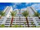 Stunning high-rise exterior with a white facade, palm trees, and blue sky creating a modern aesthetic at 150 N Las Vegas Blvd # 818, Las Vegas, NV 89101