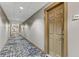 Long hallway with carpet flooring, neutral color walls and modern lighting fixtures leading to unit 818 at 150 N Las Vegas Blvd # 818, Las Vegas, NV 89101