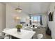 Bright living room with a modern sofa, white chairs, an entertainment center and gorgeous city views at 150 N Las Vegas Blvd # 818, Las Vegas, NV 89101
