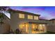Backyard view of the home featuring patio, lawn, and enclosed sunroom at 1677 Balsam Mist Ave, Las Vegas, NV 89183