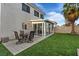 Well-maintained backyard with patio, dining set, and extended sunroom at 1677 Balsam Mist Ave, Las Vegas, NV 89183