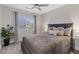 Cozy bedroom features a cushioned headboard, soft grey textiles, and natural lighting at 1677 Balsam Mist Ave, Las Vegas, NV 89183