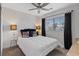 Bedroom features a queen bed, plank flooring, a ceiling fan, and natural lighting at 1677 Balsam Mist Ave, Las Vegas, NV 89183