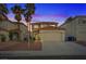 Inviting home with manicured landscaping, two car garage, and a terracotta tile roof at dusk at 1677 Balsam Mist Ave, Las Vegas, NV 89183