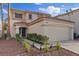 Charming two-story home with a two car garage, desert landscaping, and a terracotta tile roof at 1677 Balsam Mist Ave, Las Vegas, NV 89183