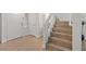 Bright foyer with wood-look tile flooring, staircase, and entry to home at 1677 Balsam Mist Ave, Las Vegas, NV 89183