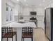 Bright kitchen features stainless steel appliances, white cabinetry, quartz countertops, and bar seating at 1677 Balsam Mist Ave, Las Vegas, NV 89183