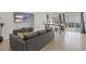 Open-concept living room featuring wood-look floors, modern furniture, and lots of natural light at 1677 Balsam Mist Ave, Las Vegas, NV 89183