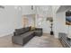 Spacious living room with wood-look floors, modern furniture, lots of natural light, and high ceilings at 1677 Balsam Mist Ave, Las Vegas, NV 89183