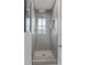 Updated bathroom features a frameless shower with gray tiling and updated fixtures at 1677 Balsam Mist Ave, Las Vegas, NV 89183