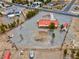 Aerial shot of a spacious gravel lot featuring a home with a red roof, and storage shed at 1800 Red Rock Dr, Pahrump, NV 89048