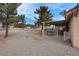 Large, fenced backyard featuring a covered patio and space for outdoor activities at 1800 Red Rock Dr, Pahrump, NV 89048