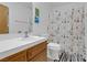 Bathroom with a white-tiled countertop and decorative shower curtain at 1800 Red Rock Dr, Pahrump, NV 89048