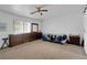 Bedroom with a ceiling fan, large window, and mirrored dresser at 1800 Red Rock Dr, Pahrump, NV 89048