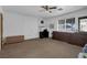 Bedroom with a ceiling fan, large window, and dark wood furniture at 1800 Red Rock Dr, Pahrump, NV 89048