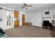 Bedroom with a ceiling fan, barn doors, and dark wood furniture at 1800 Red Rock Dr, Pahrump, NV 89048