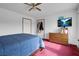 Bedroom with TV, storage dresser, and ample closet space with natural light at 1800 Red Rock Dr, Pahrump, NV 89048