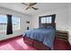 Cozy bedroom with comfy bed, large windows, and a ceiling fan above at 1800 Red Rock Dr, Pahrump, NV 89048