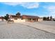 View of house and driveway with solar panels, red tile roof and mature trees in a big lot at 1800 Red Rock Dr, Pahrump, NV 89048