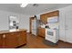 Kitchen with wood cabinets, updated stainless steel refrigerator and white appliances at 1800 Red Rock Dr, Pahrump, NV 89048