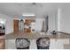 Kitchen with breakfast bar, wood cabinets, stainless steel fridge, and lighting at 1800 Red Rock Dr, Pahrump, NV 89048