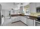 Bright kitchen with white cabinets, modern appliances, tile flooring, and a breakfast bar at 1800 Red Rock Dr, Pahrump, NV 89048