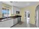 Bright kitchen with a large window, tile floors, stainless appliances, and white cabinets at 1800 Red Rock Dr, Pahrump, NV 89048