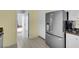 Kitchen area with stainless steel refrigerator and white cabinets, creating a clean design at 1800 Red Rock Dr, Pahrump, NV 89048