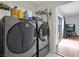 Modern laundry room featuring front loading washer and dryer, and natural light at 1800 Red Rock Dr, Pahrump, NV 89048