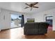 Cozy living room with hardwood floors, a large sliding glass door, and comfortable seating at 1800 Red Rock Dr, Pahrump, NV 89048