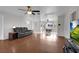 Open-concept living room with ample natural light, ceiling fan, and hardwood flooring at 1800 Red Rock Dr, Pahrump, NV 89048