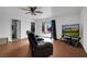 Inviting living room with wood floors, TV, and sliding doors for natural light and backyard view at 1800 Red Rock Dr, Pahrump, NV 89048