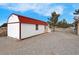 Detached outbuilding on a spacious lot, featuring neutral siding and a red roof at 1800 Red Rock Dr, Pahrump, NV 89048