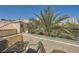 Cozy balcony with seating area and views of a palm tree and building with a tile roof at 220 E Flamingo Rd # 402, Las Vegas, NV 89169