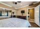 Bedroom featuring hardwood floors, mirrored closets, and in-unit washer/dryer at 220 E Flamingo Rd # 402, Las Vegas, NV 89169