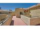 Exterior view of beige apartments with red tile roofs, balconies, and well-maintained landscaping at 220 E Flamingo Rd # 402, Las Vegas, NV 89169