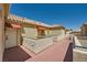 Exterior view of tan apartments with red tile roofs, balconies, and well-maintained landscaping at 220 E Flamingo Rd # 402, Las Vegas, NV 89169