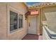 Inviting front entrance with a window and red awning providing shade to the door at 220 E Flamingo Rd # 402, Las Vegas, NV 89169