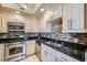 Stylish kitchen boasts stainless steel appliances and granite countertops with a tile backsplash at 220 E Flamingo Rd # 402, Las Vegas, NV 89169