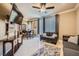 Bright living room featuring tile floors, a ceiling fan, and comfortable gray couches at 220 E Flamingo Rd # 402, Las Vegas, NV 89169