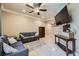 Comfortable living room featuring tile floors, a ceiling fan, and comfortable gray couches at 220 E Flamingo Rd # 402, Las Vegas, NV 89169