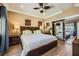 Cozy main bedroom with a large bed, wood floors, and sliding mirror door closet at 220 E Flamingo Rd # 402, Las Vegas, NV 89169