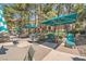 Community pool area with lounge chairs, tables, and umbrellas for a relaxing outdoor experience at 220 E Flamingo Rd # 402, Las Vegas, NV 89169