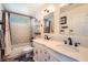 Bright bathroom featuring a double sink vanity with a shower-tub combination and decorative mirrors at 2288 Red Alder St, Henderson, NV 89002
