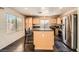 Bright, open kitchen with an island, stainless steel appliances, and ample cabinet space at 2288 Red Alder St, Henderson, NV 89002