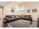Spacious living room with vaulted ceiling, hardwood floors, and a large window at 2288 Red Alder St, Henderson, NV 89002