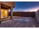 Exterior view of backyard patio area with pavers, rock landscaping, and a privacy wall at 261 Crimson Edge St, Henderson, NV 89012